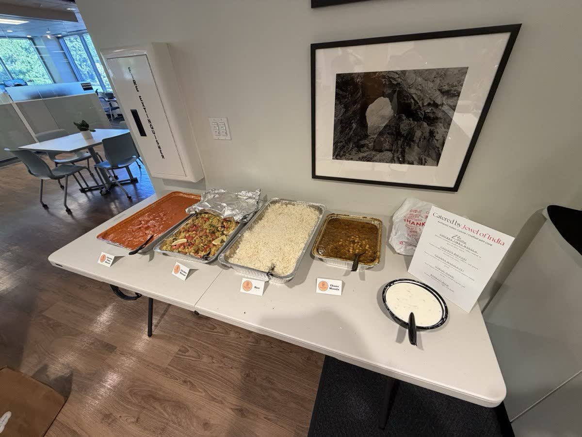 Indian catering trays and a menu card set out on a table in an office